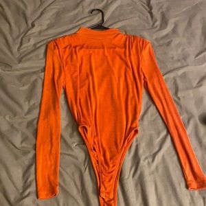 Orange turtleneck bodysuit